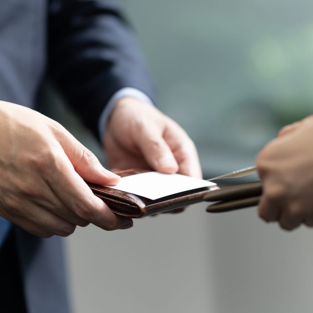 Japanese business people exchanging business cards in the office