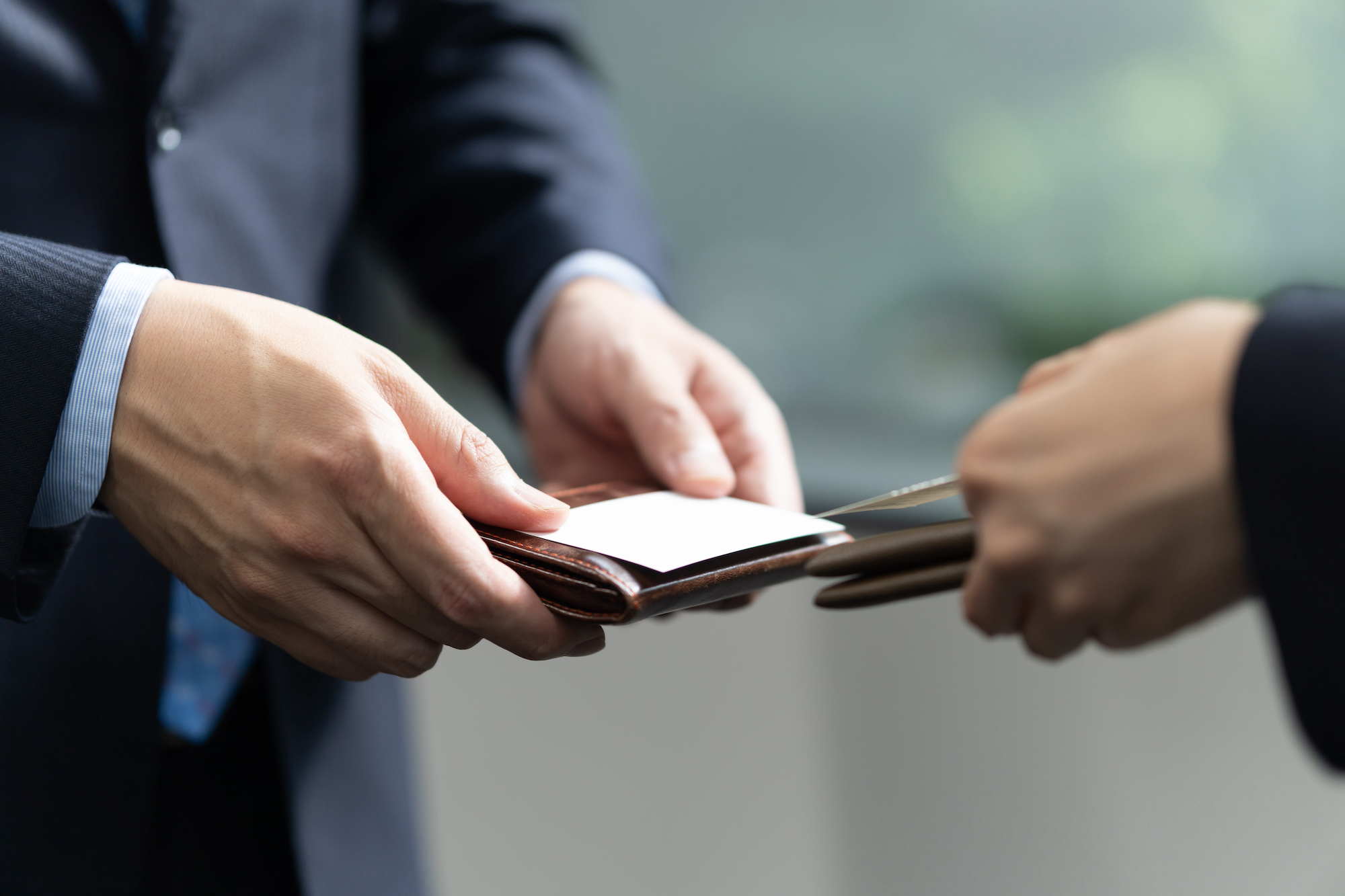 Japanese business people exchanging business cards in the office